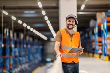 A happy worker wearing voice technology headphone