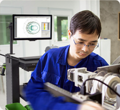 Man working next to a Mobile Computer Workstation in a manufacturing setting 